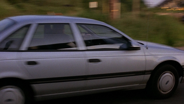 Frame from The Accused — street, car, wheel