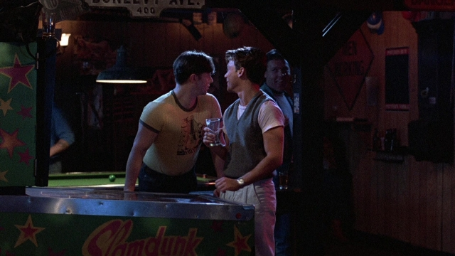 Wide shot frame from The Accused — standing, room, shirt