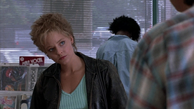 Wide shot frame from The Accused — standing, shirt, jacket