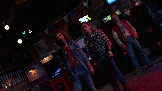 Wide shot frame from The Accused — standing, walking, room