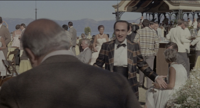 Wide shot frame from The Godfather: Part II — standing, table, dialogue