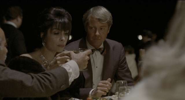 Wide shot frame from The Godfather: Part II — sitting, table, dialogue