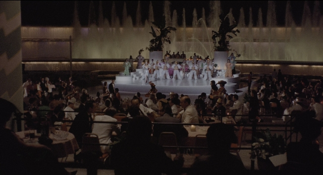Wide shot frame from The Godfather: Part II — sitting, room, fountain