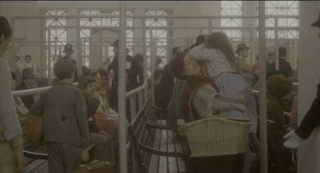 Wide shot frame from The Godfather: Part II — sitting, standing, room