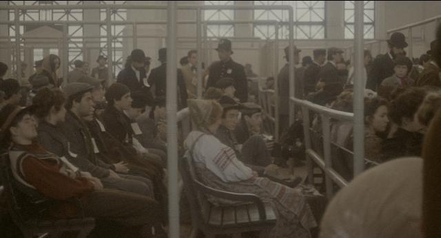 Wide shot frame from The Godfather: Part II — sitting, standing, train