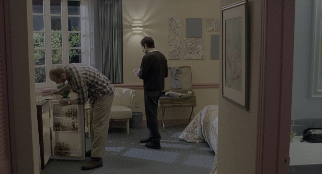 Wide shot frame from There's Something About Mary — standing, room, dialogue