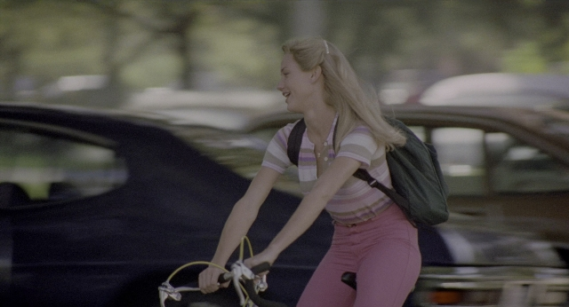 Wide shot frame from There's Something About Mary — street, car, bicycle