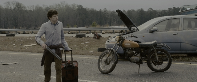 Wide shot frame from Zombieland — standing, street, car