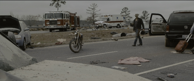 Wide shot frame from Zombieland — walking, street, hat