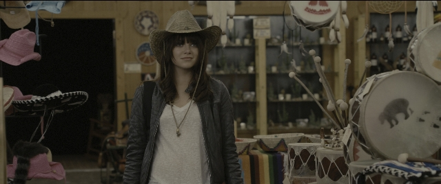 Wide shot frame from Zombieland — standing, room, hat