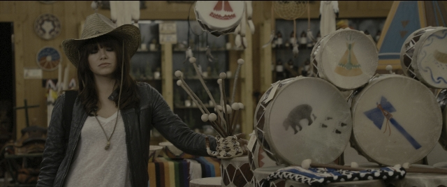 Wide shot frame from Zombieland — standing, hat, jacket