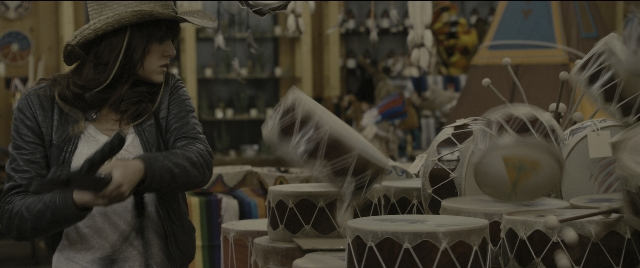 Wide shot frame from Zombieland — standing, room, hat