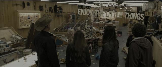 Wide shot frame from Zombieland — standing, room, mirror