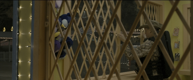 Wide shot frame from Zombieland — standing, hat, bird