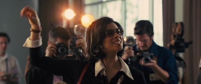 Wide shot frame from Battle of the Sexes — room, hand, camera