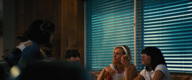 Wide shot frame from Battle of the Sexes — sitting, table, dialogue