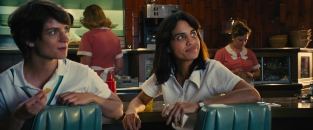 Wide shot frame from Battle of the Sexes — sitting, table, restaurant