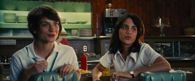 Wide shot frame from Battle of the Sexes — sitting, table, kitchen