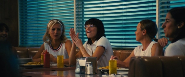 Wide shot frame from Battle of the Sexes — sitting, table, dialogue
