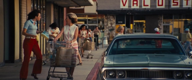 Medium shot frame from Battle of the Sexes — walking, dialogue, street