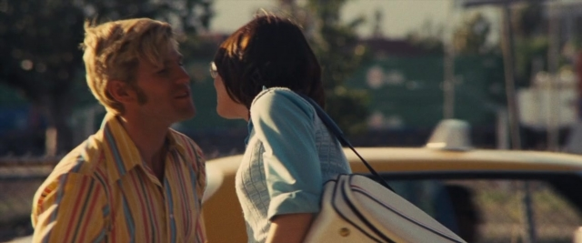 Wide shot frame from Battle of the Sexes — standing, street, car