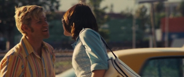 Wide shot frame from Battle of the Sexes — standing, car, shirt
