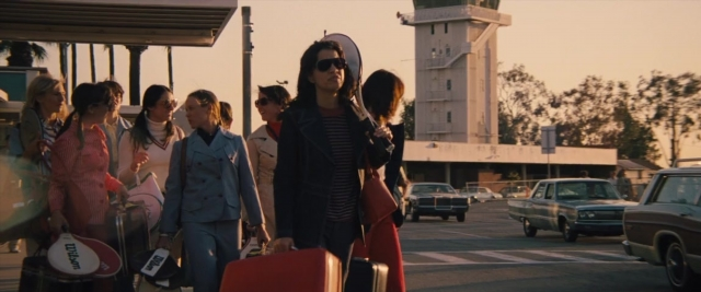 Wide shot frame from Battle of the Sexes — standing, walking, street