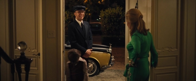 Wide shot frame from Battle of the Sexes — standing, door, hat