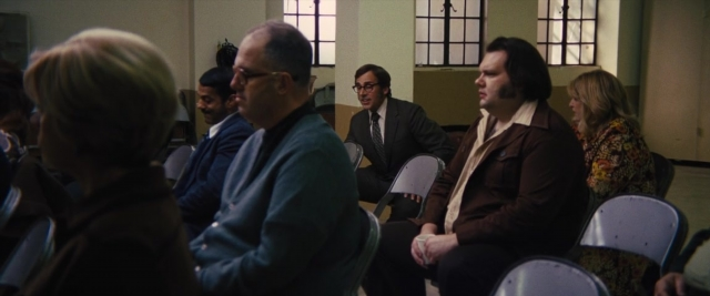 Wide shot frame from Battle of the Sexes — sitting, room, dialogue