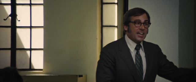 Wide shot frame from Battle of the Sexes — standing, room, dialogue