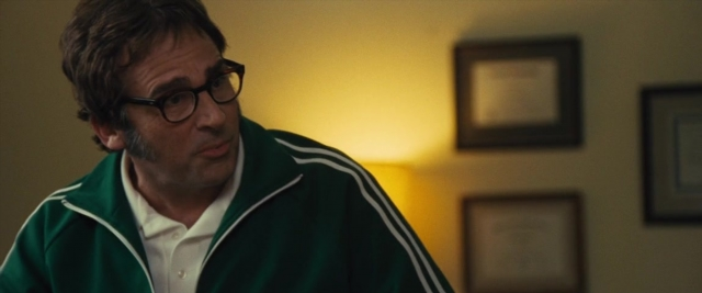 Medium shot frame from Battle of the Sexes — standing, room, beard