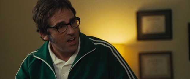 Medium shot frame from Battle of the Sexes — standing, room, beard