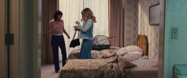 Medium shot frame from Battle of the Sexes — standing, room, dialogue