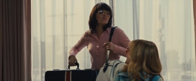 Wide shot frame from Battle of the Sexes — standing, hand, face