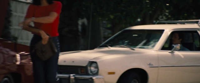 Frame from Battle of the Sexes — sitting, standing, street