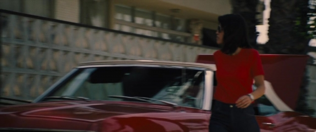 Wide shot frame from Battle of the Sexes — standing, street, car