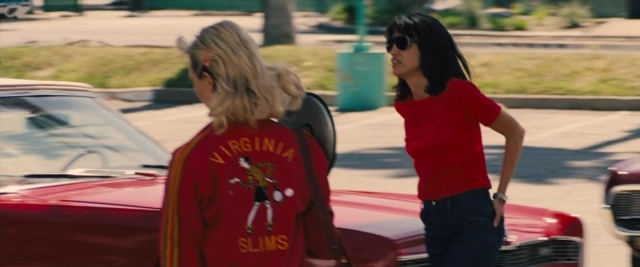 Medium shot frame from Battle of the Sexes — standing, dialogue, street
