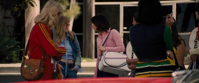 Wide shot frame from Battle of the Sexes — standing, dialogue, phone