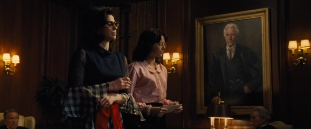 Wide shot frame from Battle of the Sexes — sitting, standing, dialogue