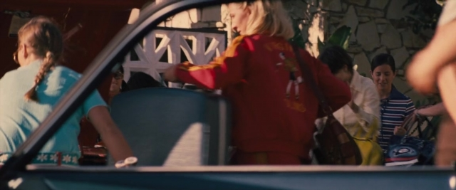 Wide shot frame from Battle of the Sexes — standing, watch, car