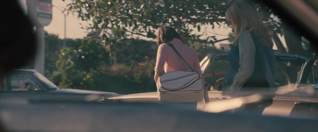 Wide shot frame from Battle of the Sexes — standing, street, car