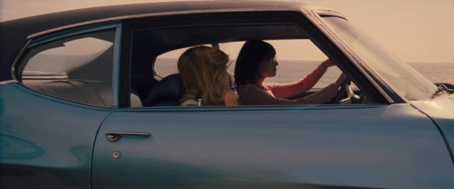 Frame from Battle of the Sexes — sitting, car, sea