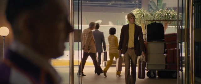 Wide shot frame from Battle of the Sexes — walking, street, hand