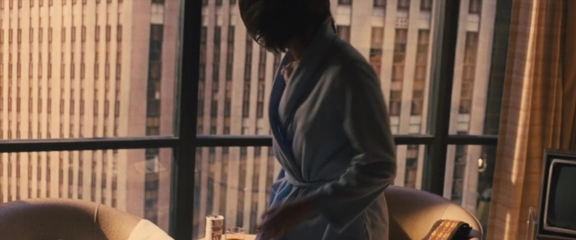 Frame from Battle of the Sexes — standing, room, table