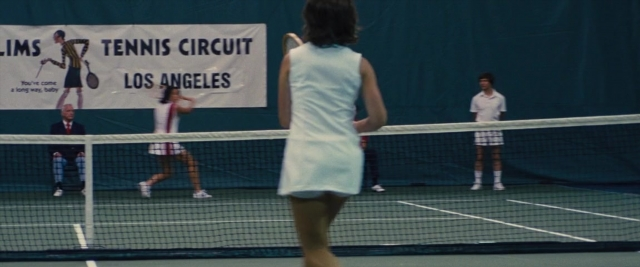 Wide shot frame from Battle of the Sexes — sitting, standing, uniform