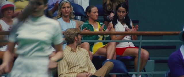 Wide shot frame from Battle of the Sexes — sitting, hat, dress