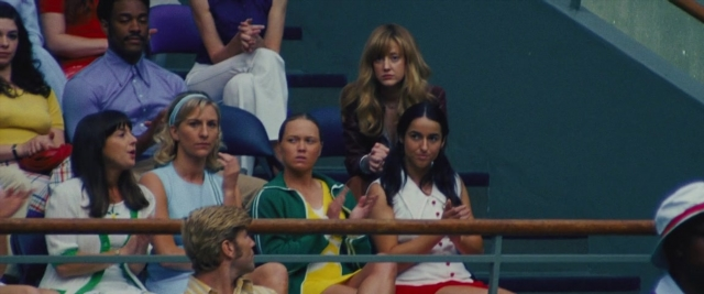 Wide shot frame from Battle of the Sexes — sitting, standing, shirt