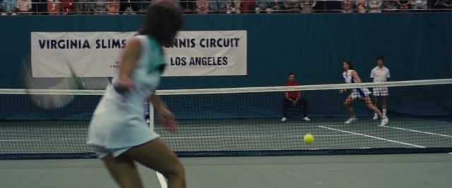 Wide shot frame from Battle of the Sexes — sitting, dress, shirt