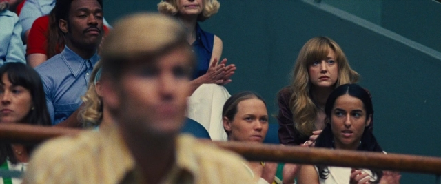 Wide shot frame from Battle of the Sexes — sitting, shirt, person