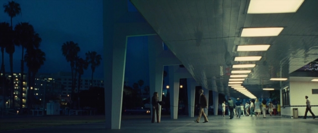 Wide shot frame from Battle of the Sexes — walking, night, person